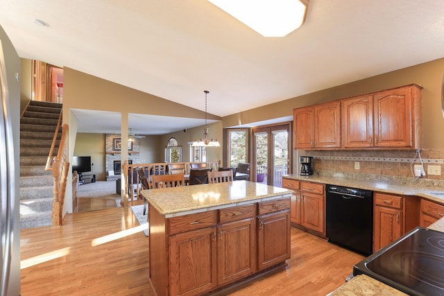 kitchen featuring dishwasher, lofted ceiling, hanging light fixtures, tasteful backsplash, and a chandelier