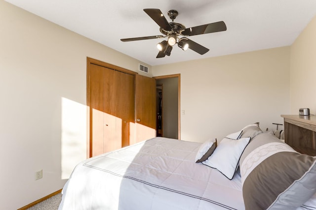 bedroom with ceiling fan, a closet, and light carpet