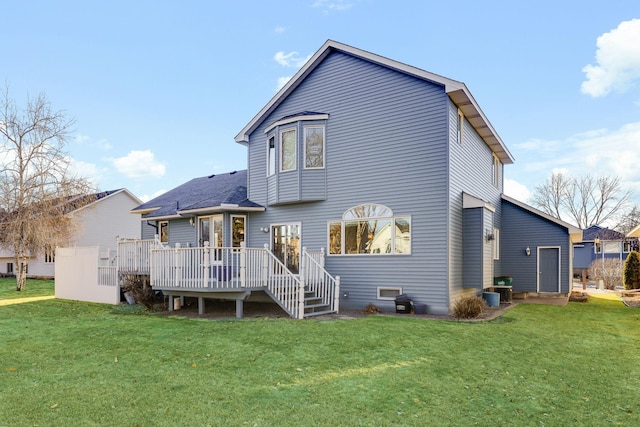 rear view of house with a yard and a deck