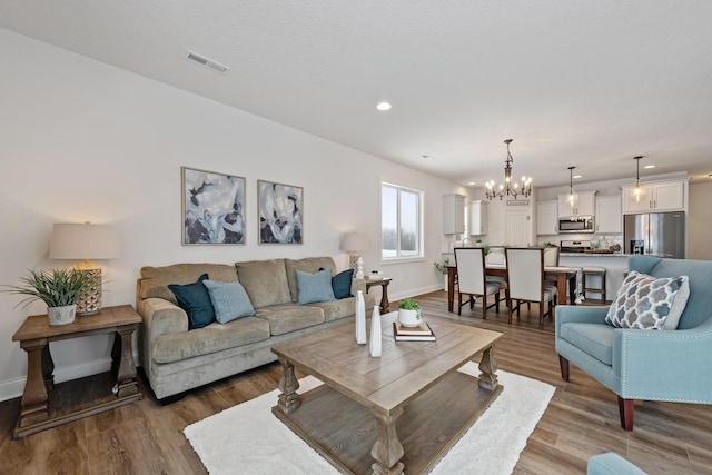 living room with a chandelier and hardwood / wood-style floors