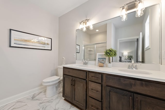 bathroom with a shower with door, vanity, and toilet