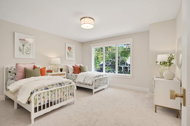 bedroom featuring light colored carpet