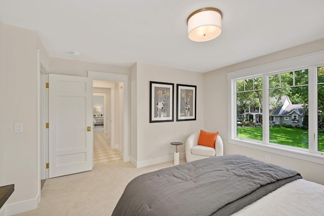 bedroom featuring light colored carpet