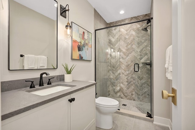 bathroom featuring vanity, toilet, a shower with door, and tile patterned floors