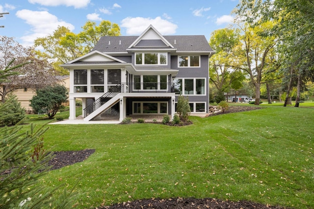 back of property with a lawn and a sunroom