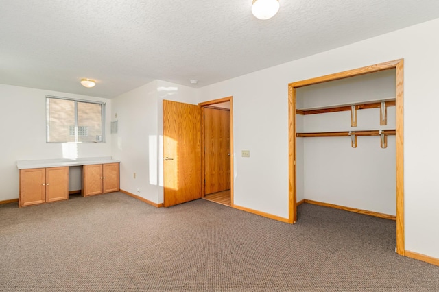 unfurnished bedroom featuring a closet, light carpet, and a textured ceiling