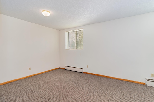 unfurnished room featuring a baseboard heating unit, carpet, and a textured ceiling