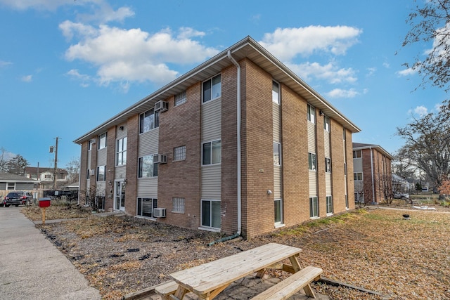 view of building exterior with a wall mounted air conditioner