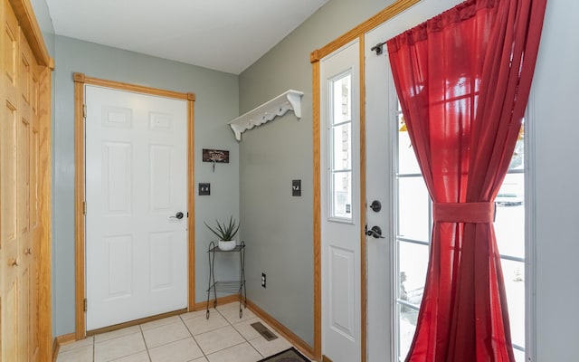 foyer featuring light tile patterned floors and a healthy amount of sunlight