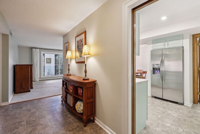 hallway with a textured ceiling