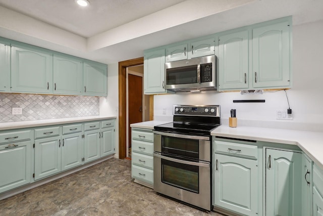 kitchen with appliances with stainless steel finishes and tasteful backsplash