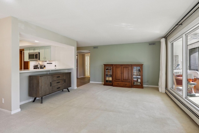 carpeted living room featuring baseboard heating