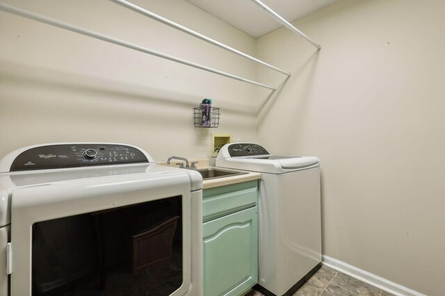 washroom featuring cabinets, independent washer and dryer, and sink