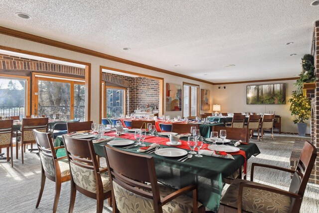 carpeted dining area with crown molding and a textured ceiling