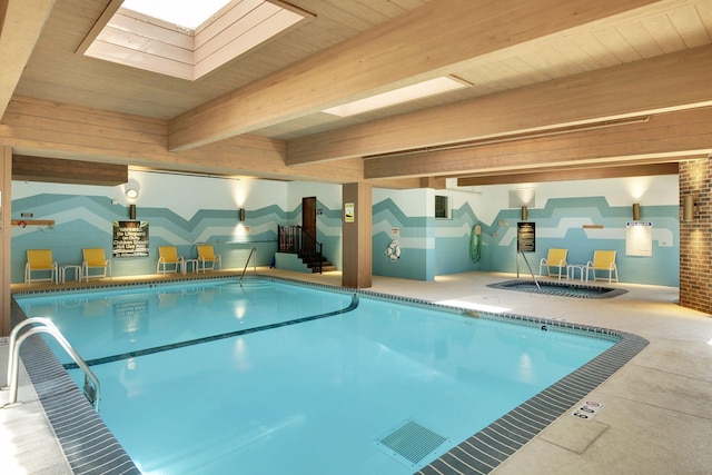 view of swimming pool featuring a skylight