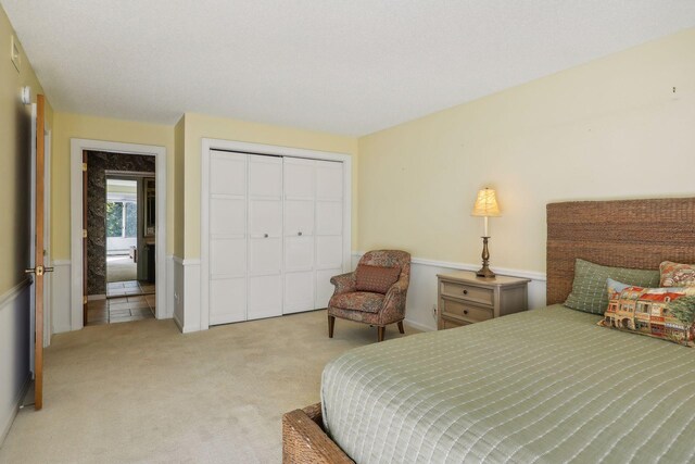 carpeted bedroom with a closet