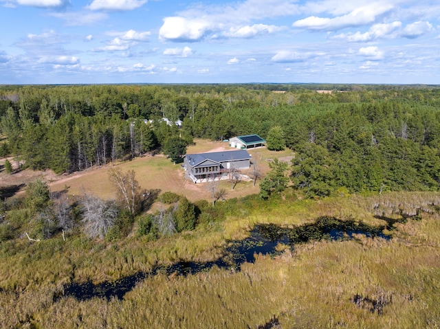 drone / aerial view featuring a wooded view