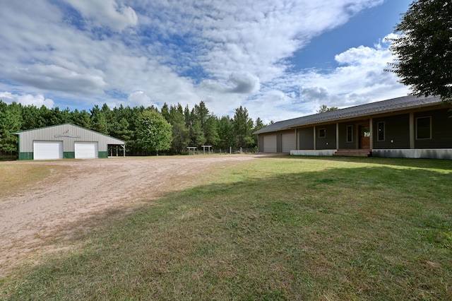 view of yard with a garage and driveway