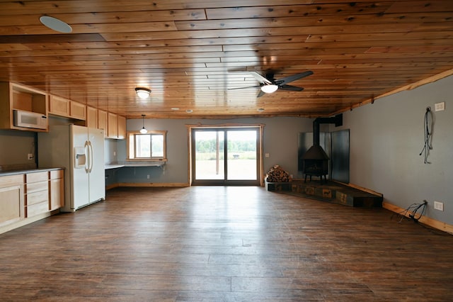 unfurnished living room featuring ceiling fan, wooden ceiling, dark wood finished floors, and a wood stove