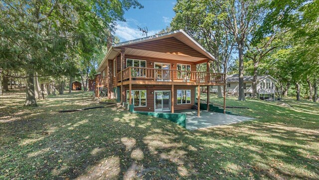 15520 Tamarac Cir NE, Miltona, MN 56354 - back of house with a yard, a deck, and a patio area