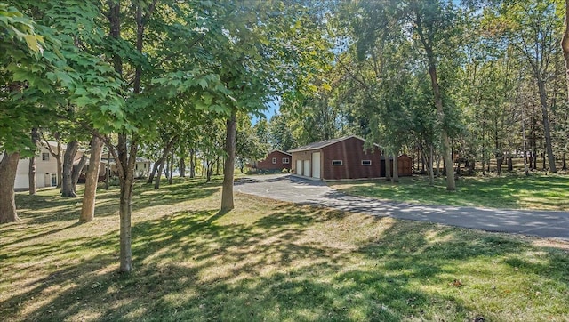15520 Tamarac Cir NE, Miltona, MN 56354 - exterior space with aphalt driveway, a garage, an outbuilding, and a front yard