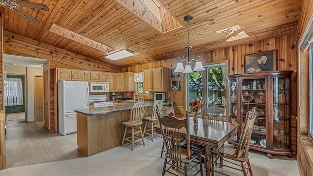 dining area with light carpet, wooden walls, and wooden ceiling