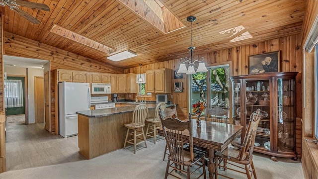 15520 Tamarac Cir NE, Miltona, MN 56354 - dining area featuring wooden ceiling, an inviting chandelier, wood walls, and lofted ceiling with skylight