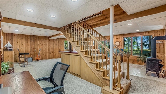 15520 Tamarac Cir NE, Miltona, MN 56354 - carpeted home office with a paneled ceiling, a wood stove, wood walls, and recessed lighting