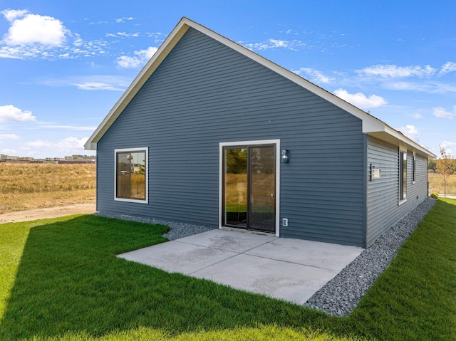 back of house featuring a yard and a patio area