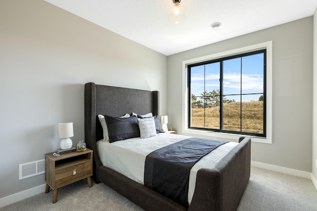 bedroom with light colored carpet