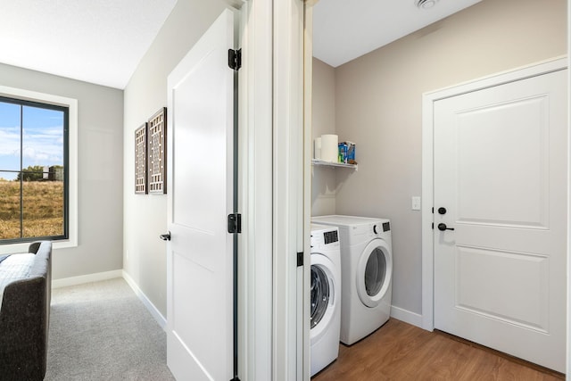 laundry room featuring hardwood / wood-style flooring and washing machine and clothes dryer