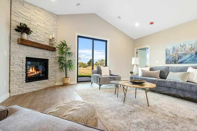 living room featuring a fireplace, vaulted ceiling, and light hardwood / wood-style flooring