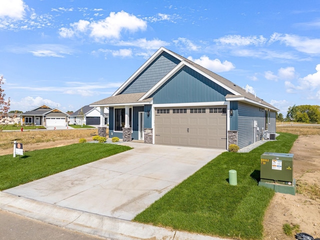 craftsman-style home featuring a garage, a front yard, and central air condition unit