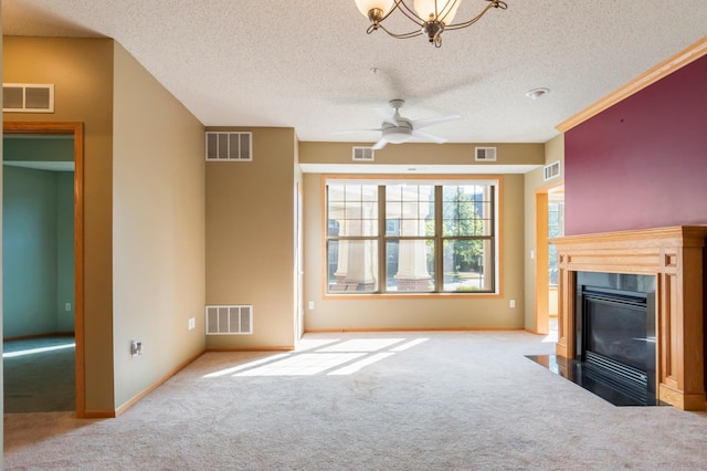 carpeted living room with ceiling fan with notable chandelier and a textured ceiling