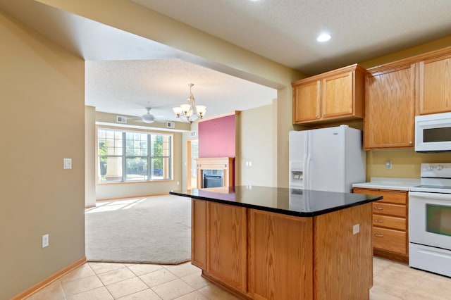 kitchen featuring ceiling fan with notable chandelier, white appliances, a textured ceiling, and light colored carpet