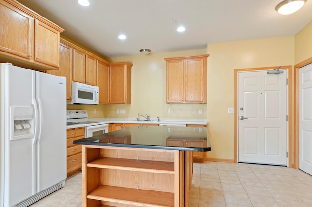 kitchen featuring light brown cabinets, sink, white appliances, and a kitchen island