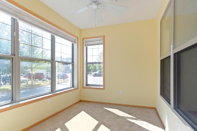 carpeted empty room featuring ceiling fan