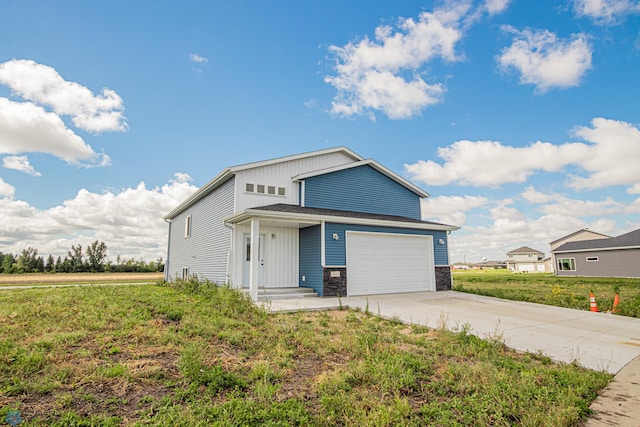 view of front of house featuring a garage and a front lawn