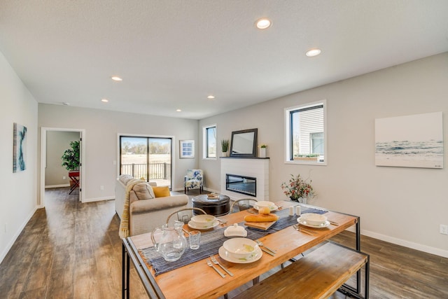 dining area featuring dark hardwood / wood-style flooring and a textured ceiling