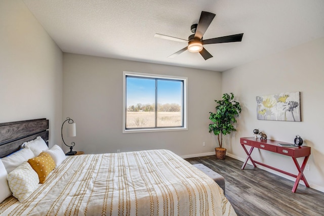 bedroom featuring a textured ceiling, wood-type flooring, and ceiling fan