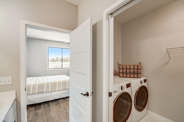 washroom featuring hardwood / wood-style flooring and washer and dryer