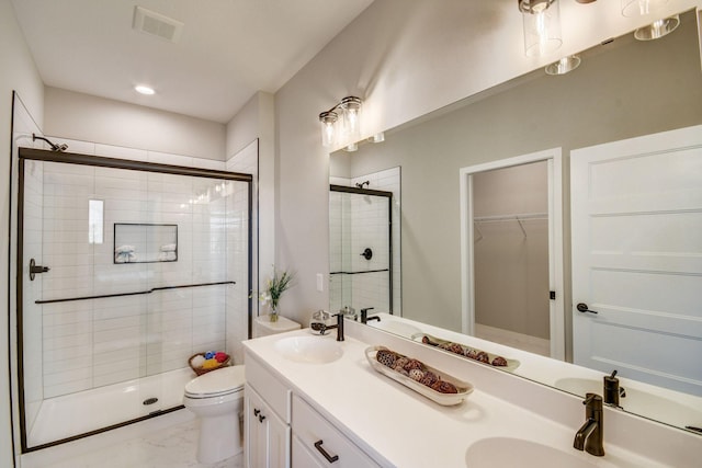 bathroom with vanity, toilet, and an enclosed shower