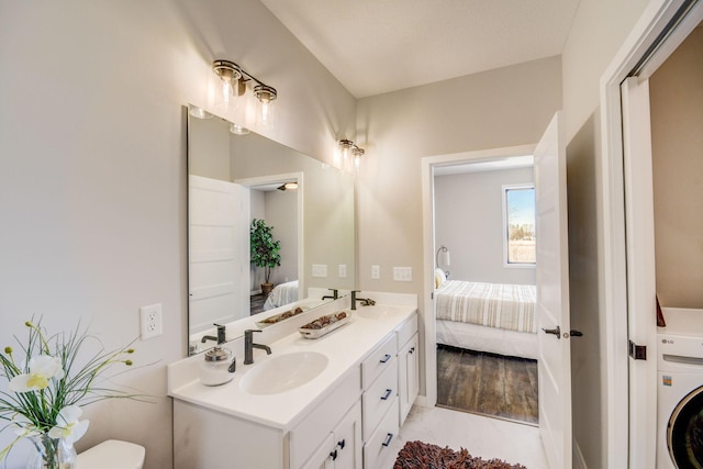 bathroom with washer / clothes dryer, wood-type flooring, and vanity