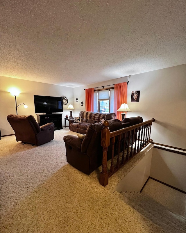 living room with carpet floors and a textured ceiling