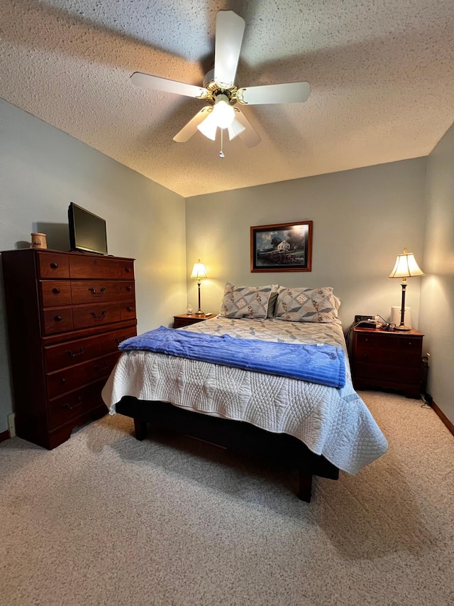 carpeted bedroom with a textured ceiling and ceiling fan