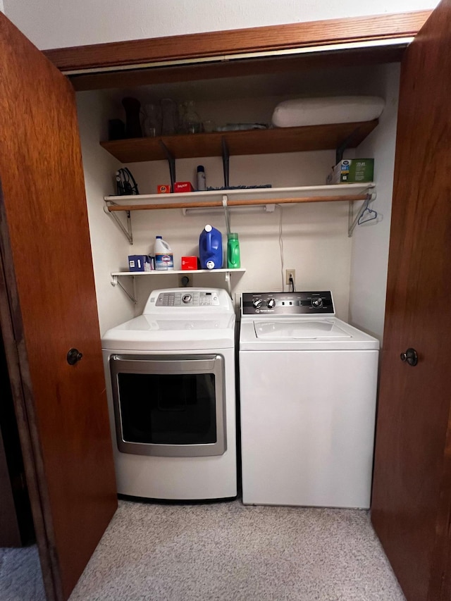 laundry area featuring washer and dryer and light colored carpet