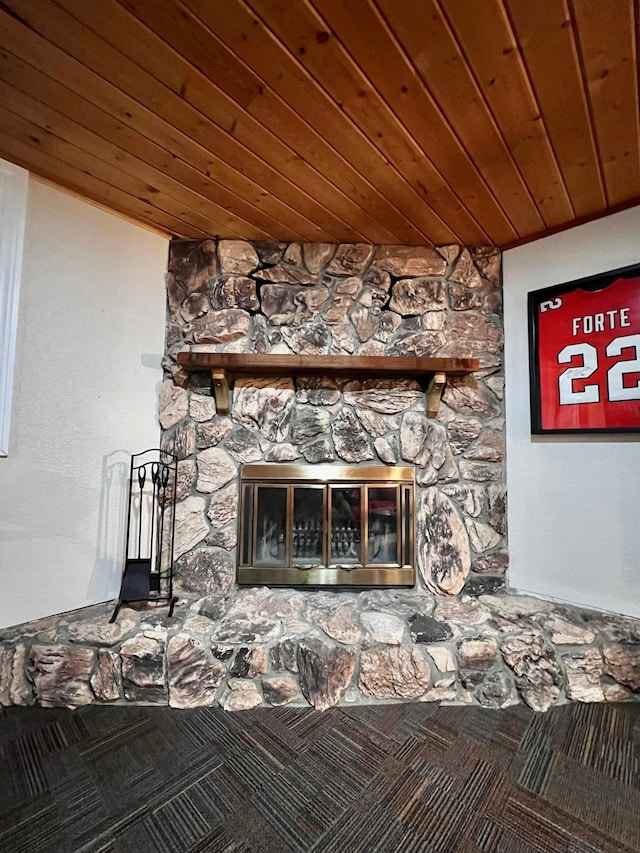 details featuring carpet flooring, a stone fireplace, and wooden ceiling