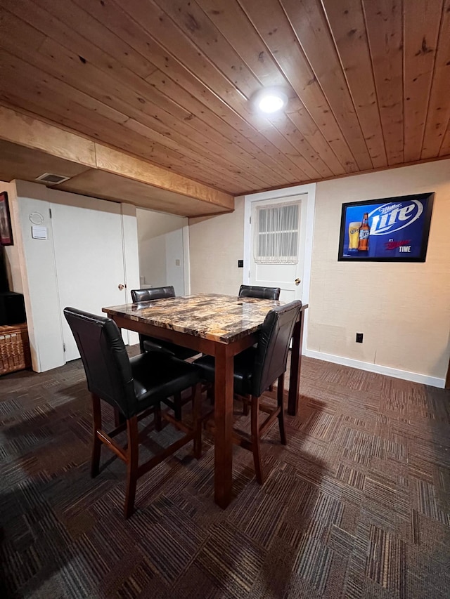 dining room with dark carpet and wooden ceiling