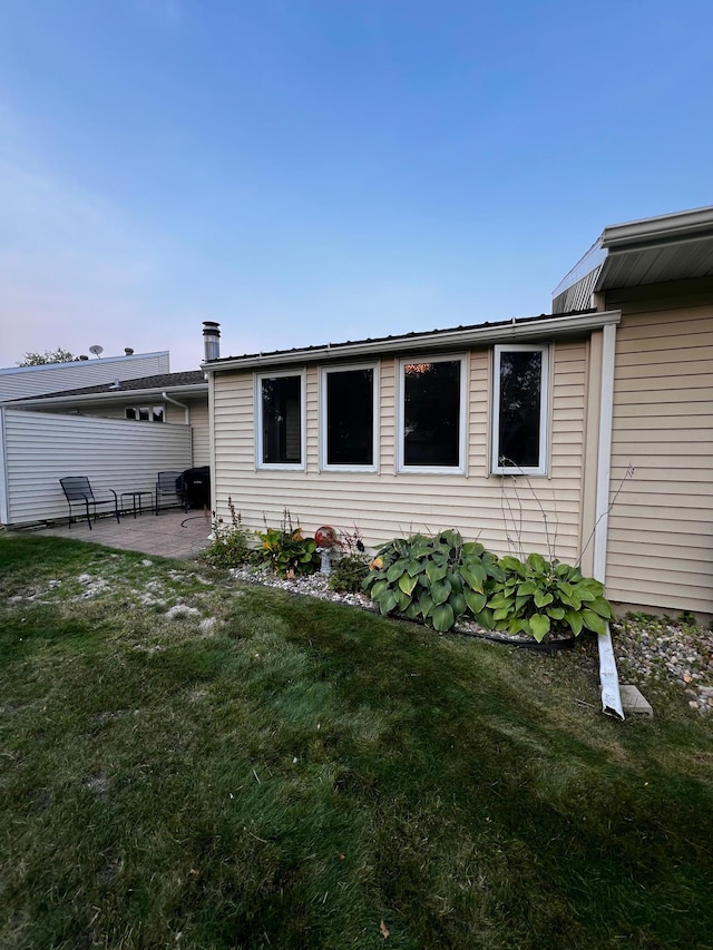 rear view of property with a patio area and a lawn