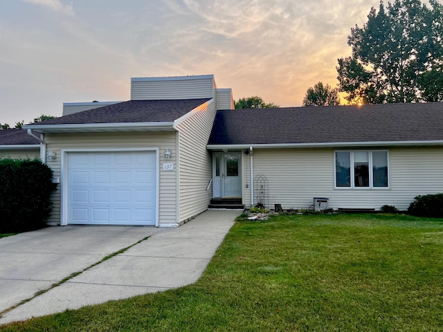 single story home with a yard and a garage